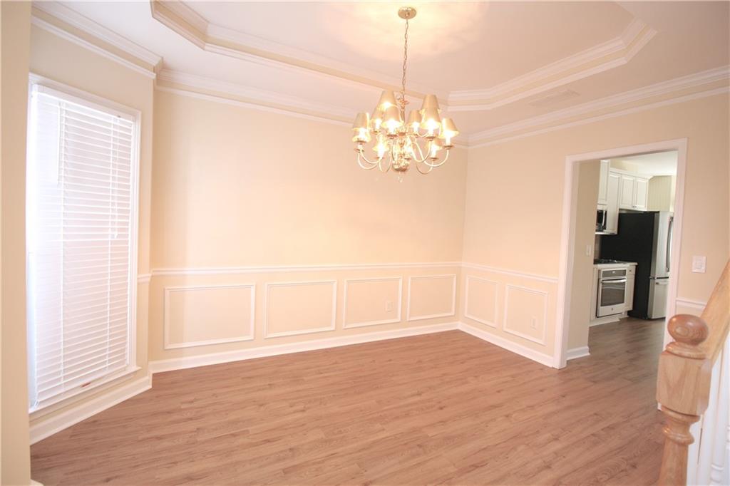 3343 Mill Grove Terrace Dacula, GA 30019 - Photo 3 of 28 a view of a livingroom with a chandelier wooden floor and chandelier