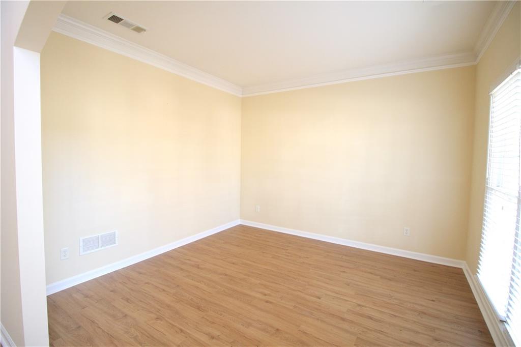 3343 Mill Grove Terrace Dacula, GA 30019 - Photo 4 of 28 a view of empty room with wooden floor and fan