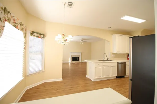 a view of a kitchen with a stove cabinets and a wooden floor