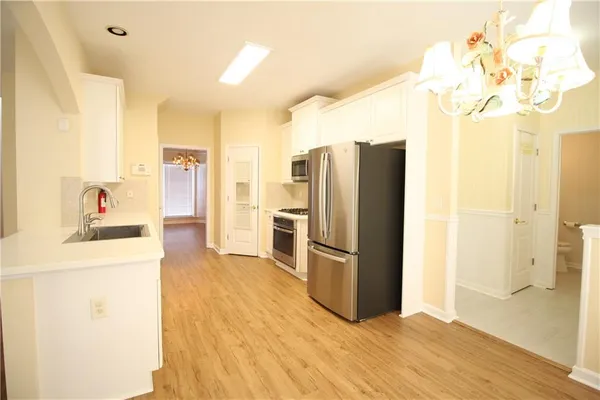 a kitchen with stainless steel appliances a refrigerator and a stove