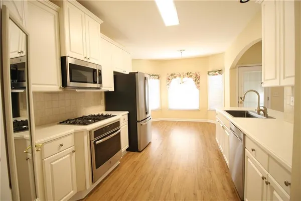 a kitchen with a sink stove and refrigerator