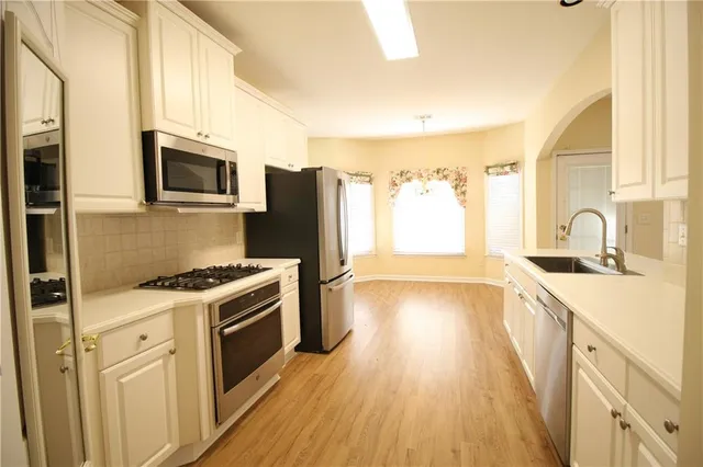 a kitchen with a sink stove and refrigerator