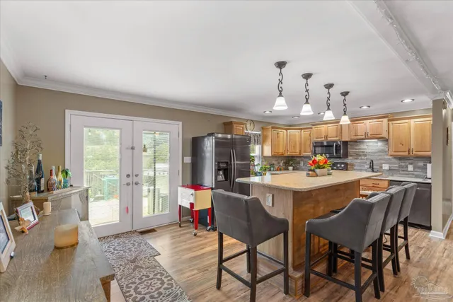 a kitchen with stainless steel appliances granite countertop a sink a stove and a refrigerator