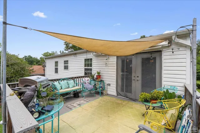 a view of a house with backyard sitting area and garden
