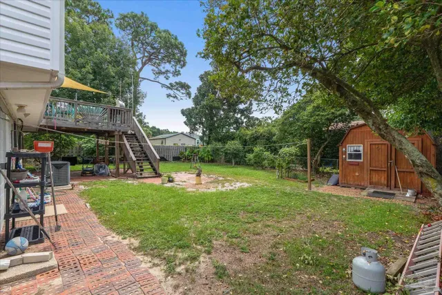 a view of a house with a backyard