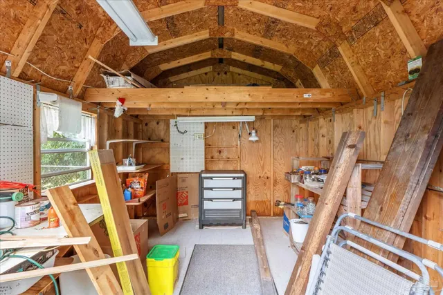 a view of a chair and table in backyard of the house