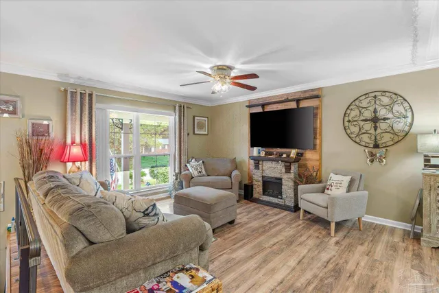 a living room with furniture a flat screen tv and a large window