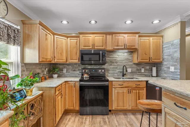a kitchen with a sink stove and cabinets