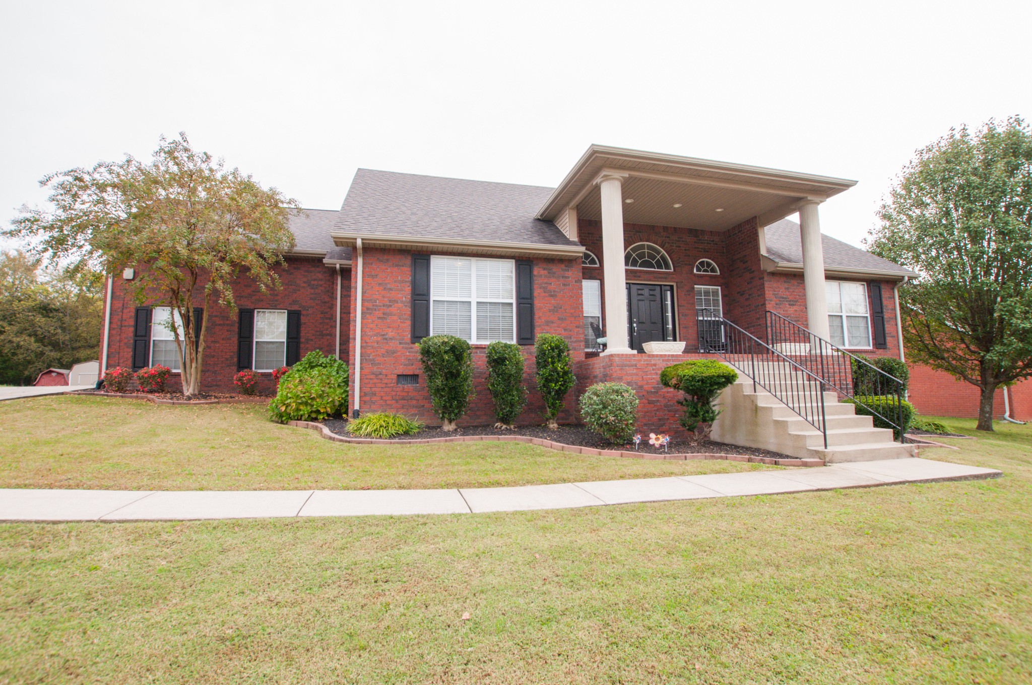 596 Windy Road Mount Juliet, TN 37122 - Photo 1 of 34 a front view of a house with a garden