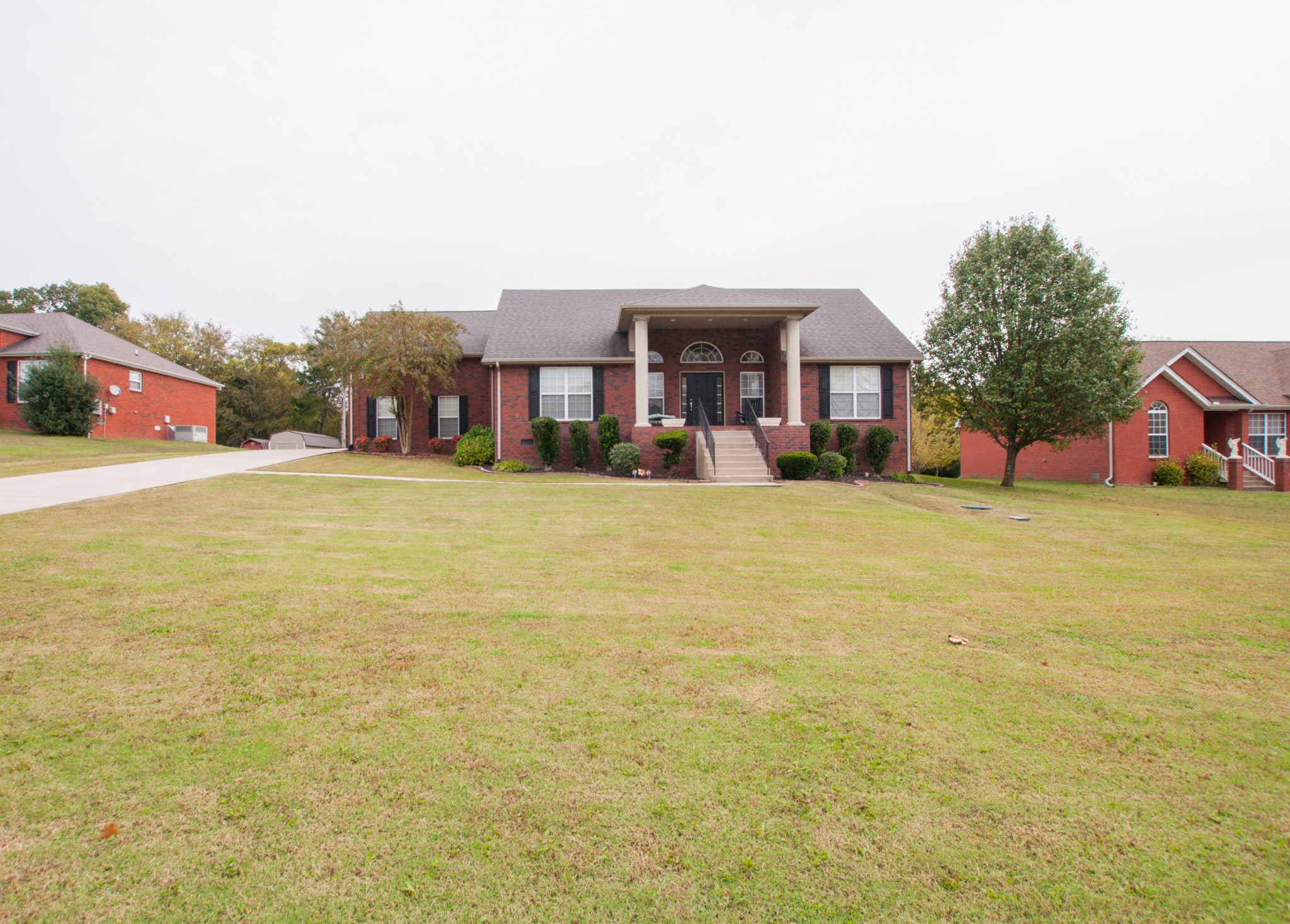 596 Windy Road Mount Juliet, TN 37122 - Photo 2 of 34 a view of a house with a yard and a garage