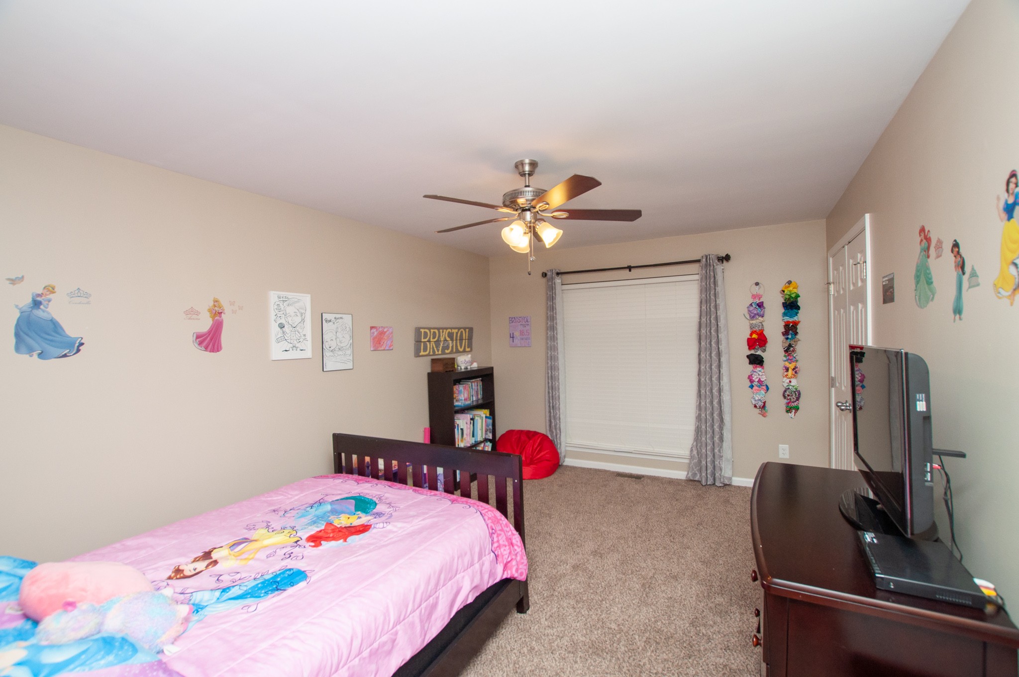 596 Windy Road Mount Juliet, TN 37122 - Photo 22 of 34 a bedroom with a bed and a chandelier
