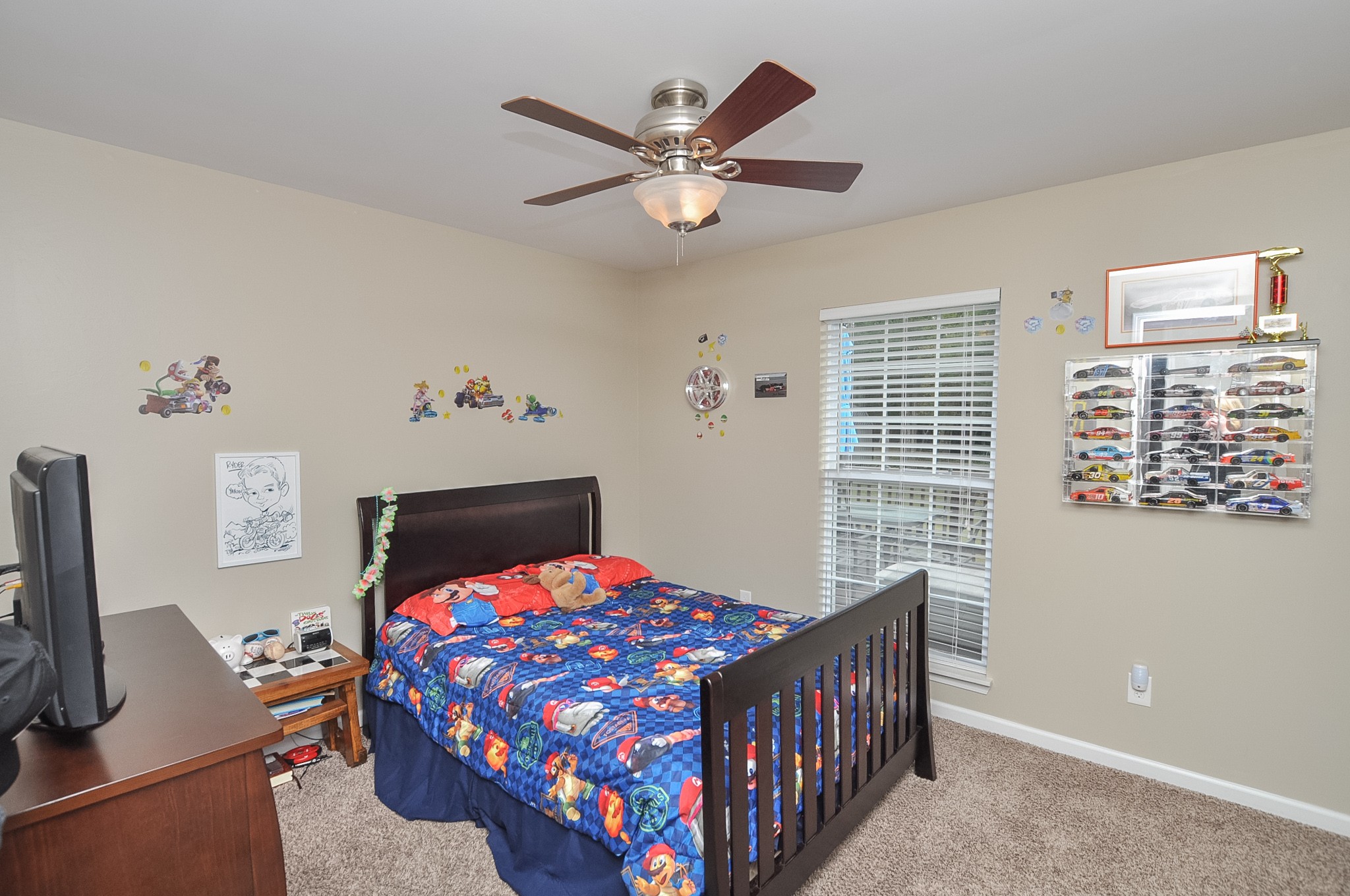 596 Windy Road Mount Juliet, TN 37122 - Photo 23 of 34 a bedroom with a bed and a chandelier