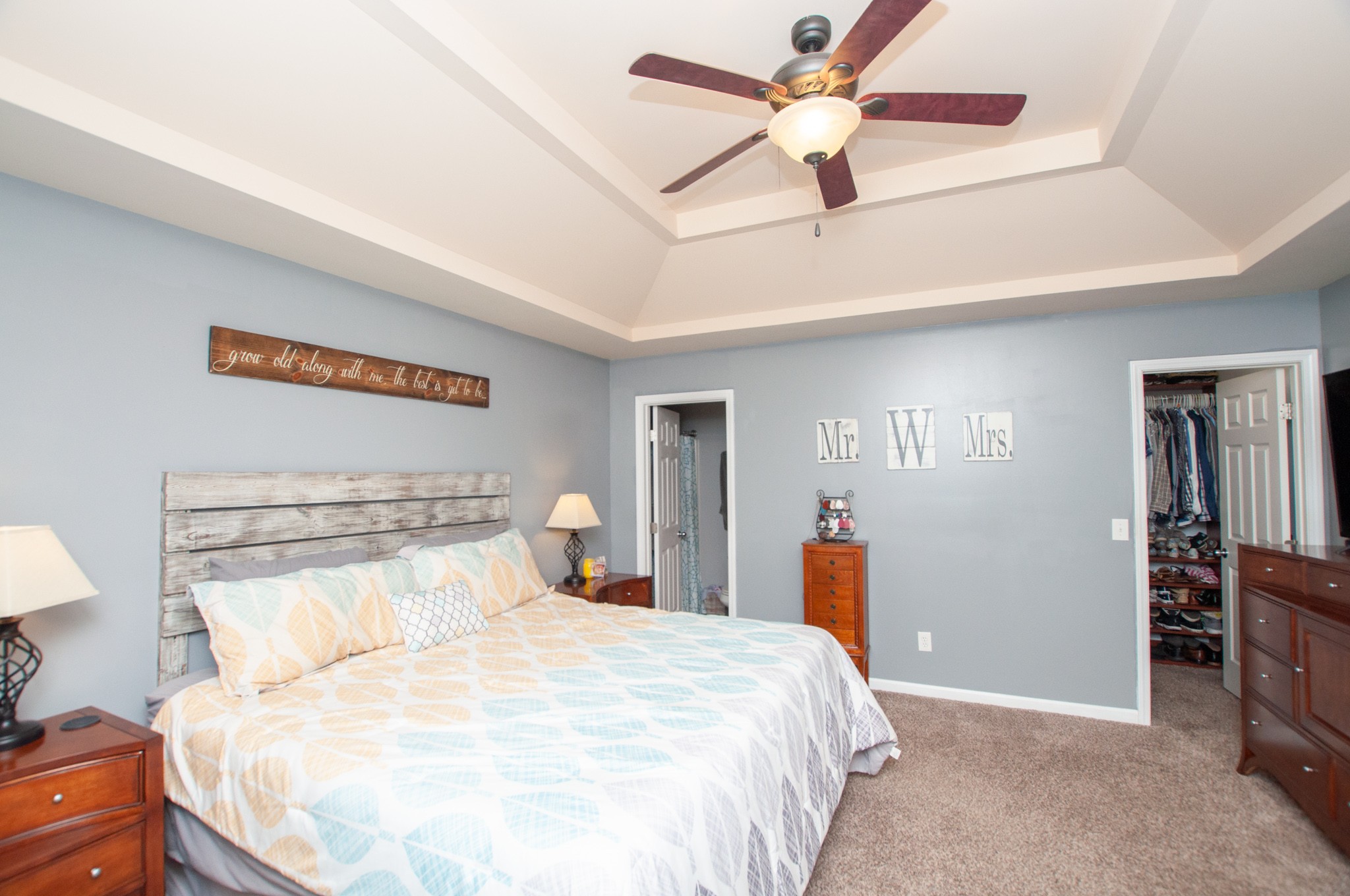 596 Windy Road Mount Juliet, TN 37122 - Photo 10 of 34 a bedroom with a bed and a chandelier