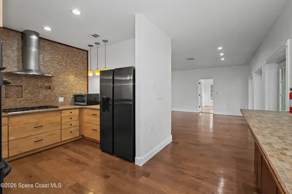 a kitchen with a refrigerator and a sink