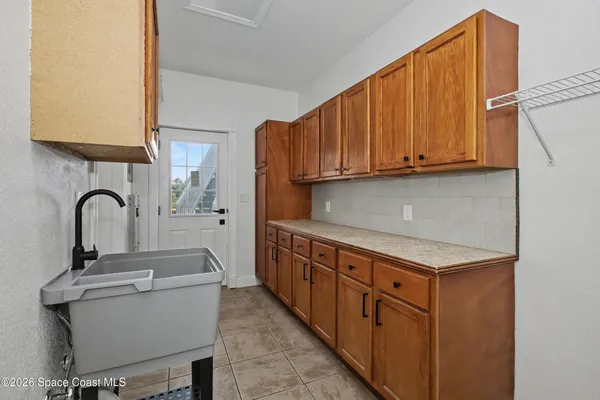 a kitchen with a sink cabinets and appliances