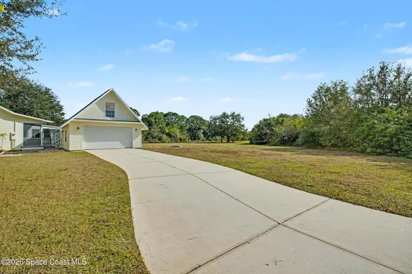 a view of house with garden and pathway