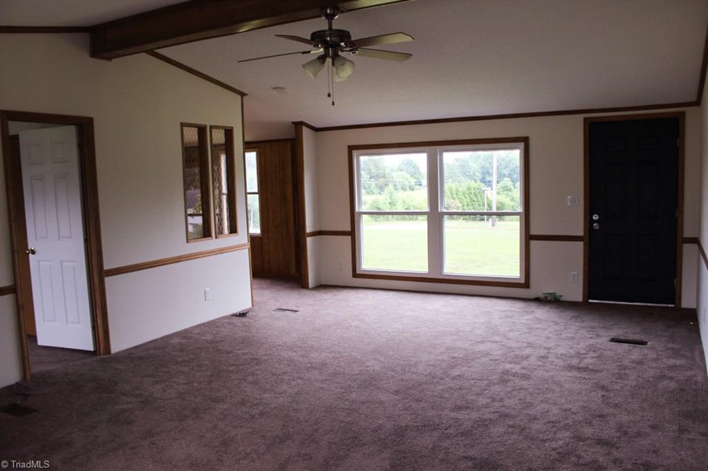 1040 Countryrock Road Germanton, NC 27019 - Photo 8 of 22 living room pictured from the sliding doors / covered deck. Master bedroom is on the back left, dining room on the left front