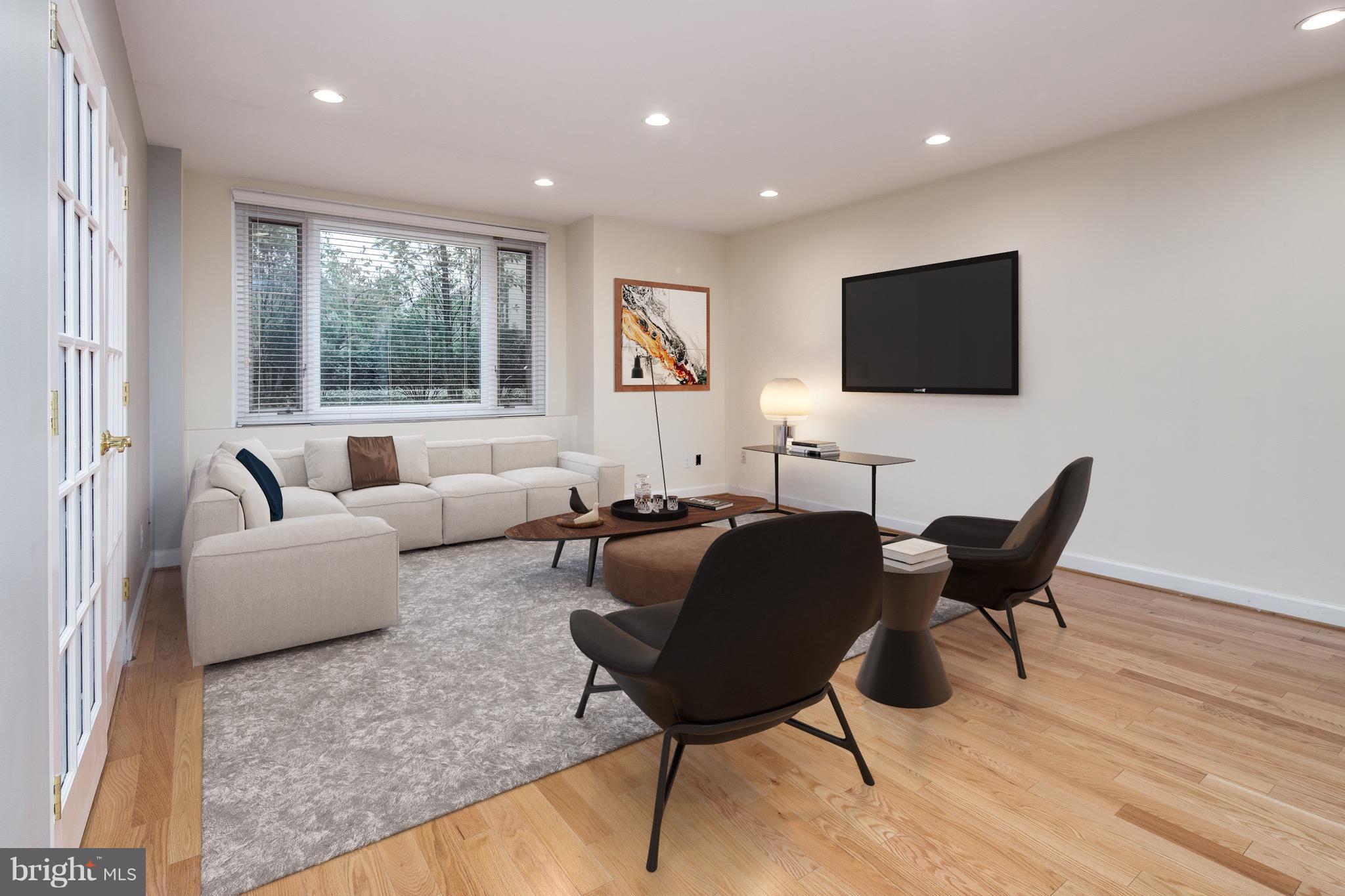 2475 Virginia Avenue Northwest, Unit 103 Washington, DC 20037 - Photo 2 of 16 a living room with furniture and a flat screen tv