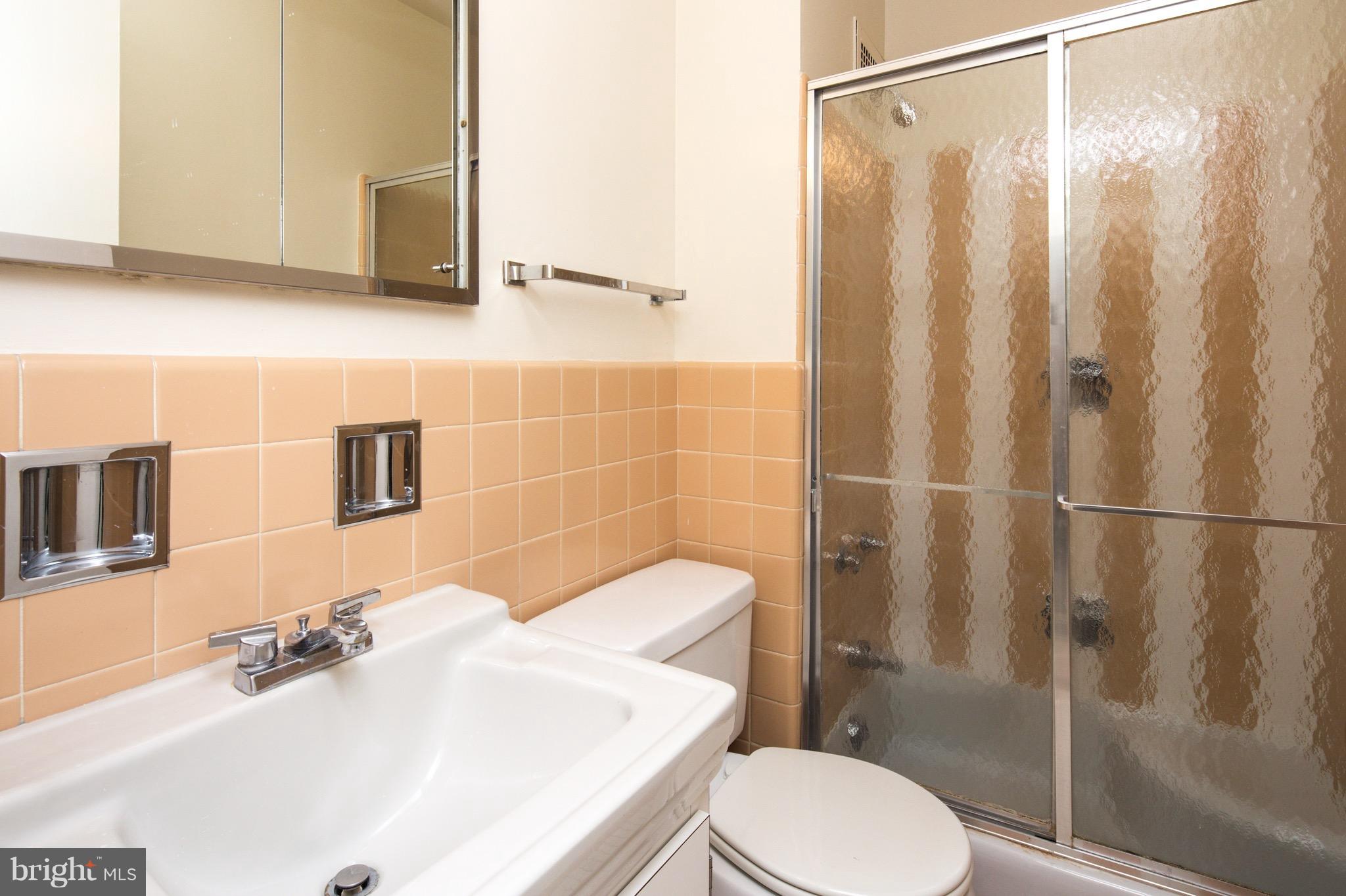2475 Virginia Avenue Northwest, Unit 103 Washington, DC 20037 - Photo 12 of 16 a bathroom with a sink toilet and shower
