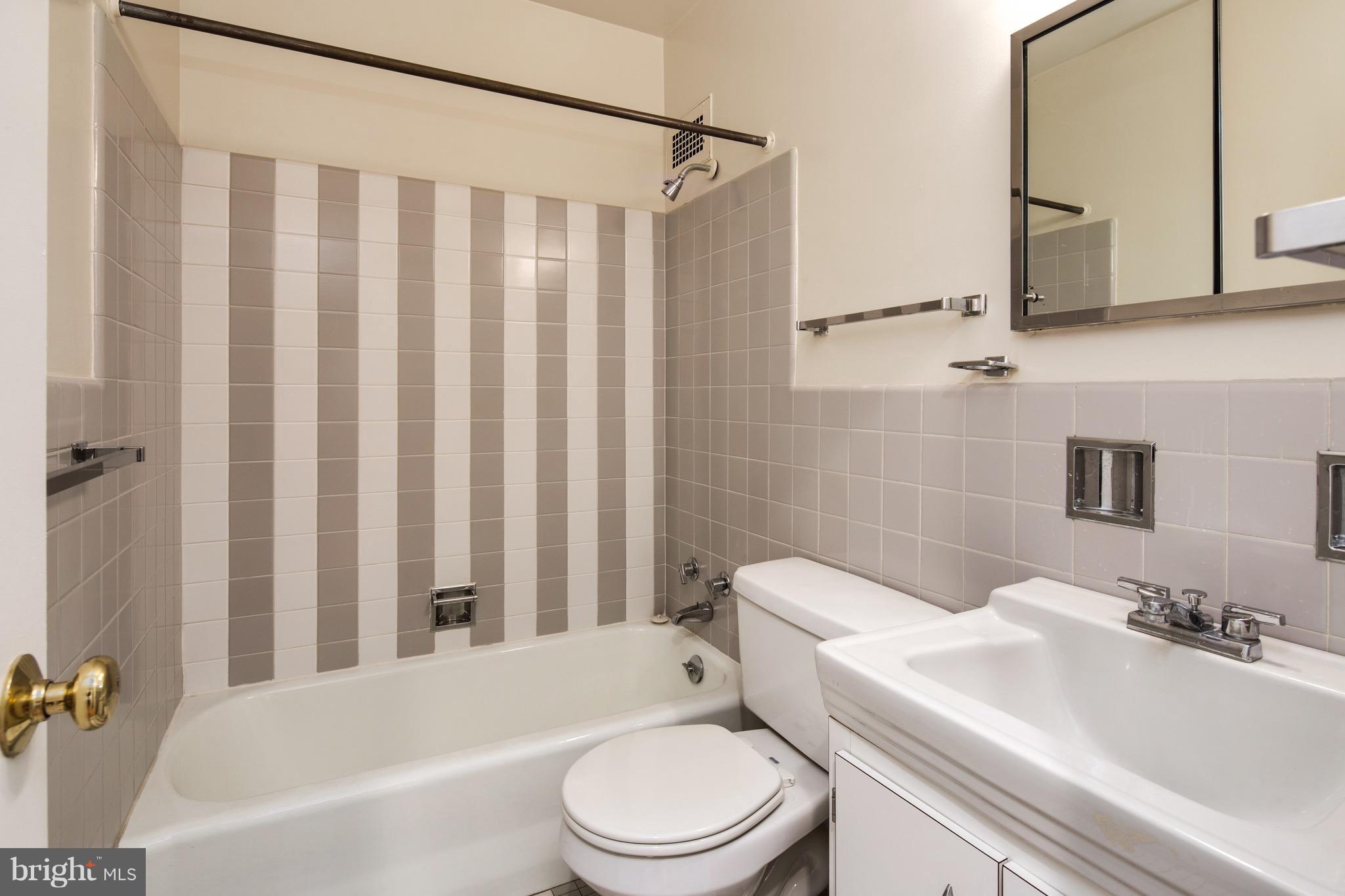 2475 Virginia Avenue Northwest, Unit 103 Washington, DC 20037 - Photo 13 of 16 a bathroom with a toilet a sink and a bathtub