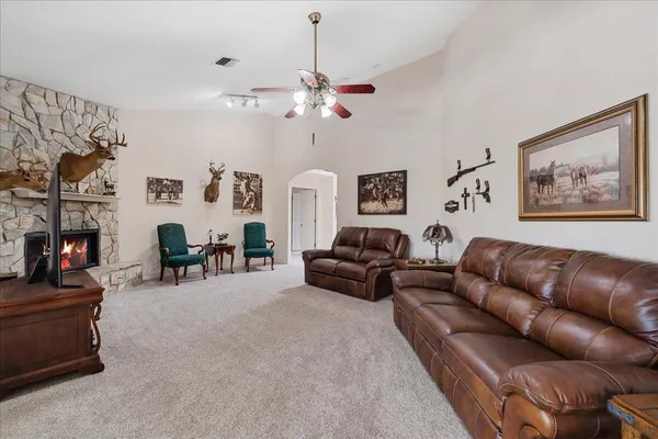 a living room with furniture a fireplace and white walls