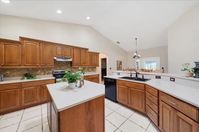 a kitchen with granite countertop a sink and cabinets