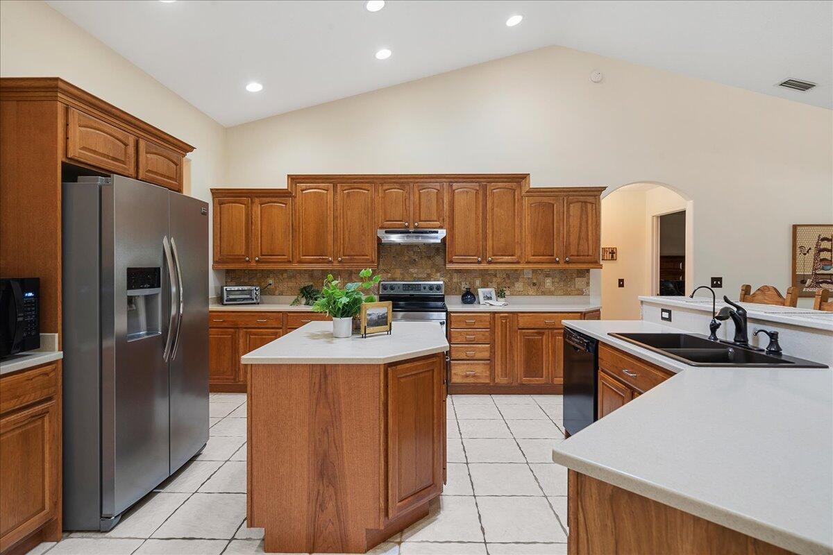 3125 Davis Road Mims, FL 32754 - Photo 17 of 46 a kitchen with stainless steel appliances granite countertop a sink refrigerator and cabinets