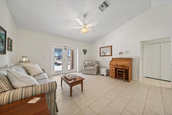 a bedroom with furniture and a ceiling fan
