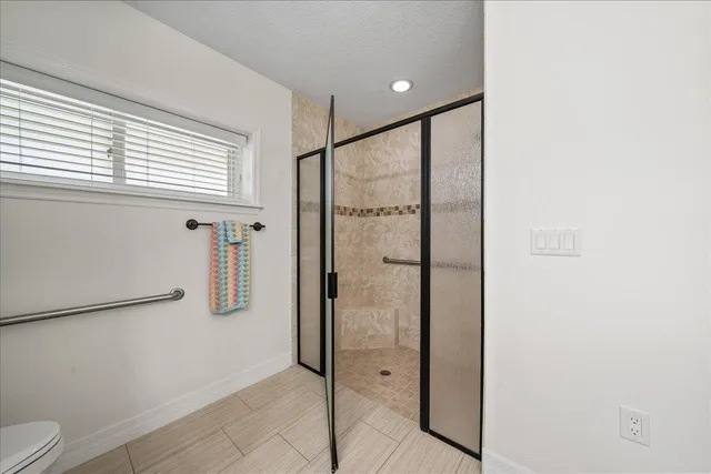 a bathroom with a shower and a toilet