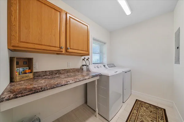 a utility room with a sink washer and dryer