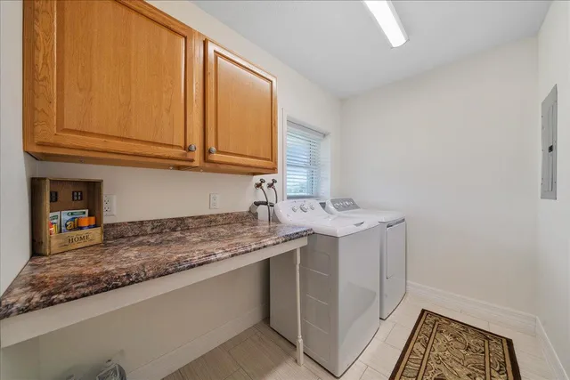 a utility room with a sink washer and dryer