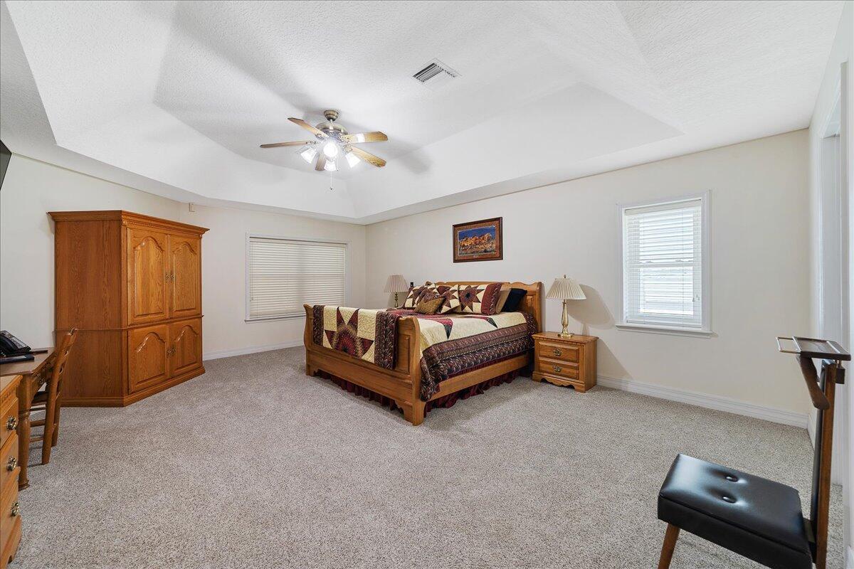 3125 Davis Road Mims, FL 32754 - Photo 8 of 46 a spacious bedroom with a bed and a chair