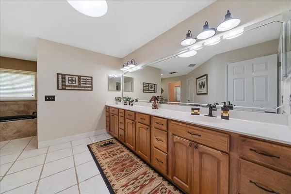 a spacious bathroom with a double vanity sink mirror and