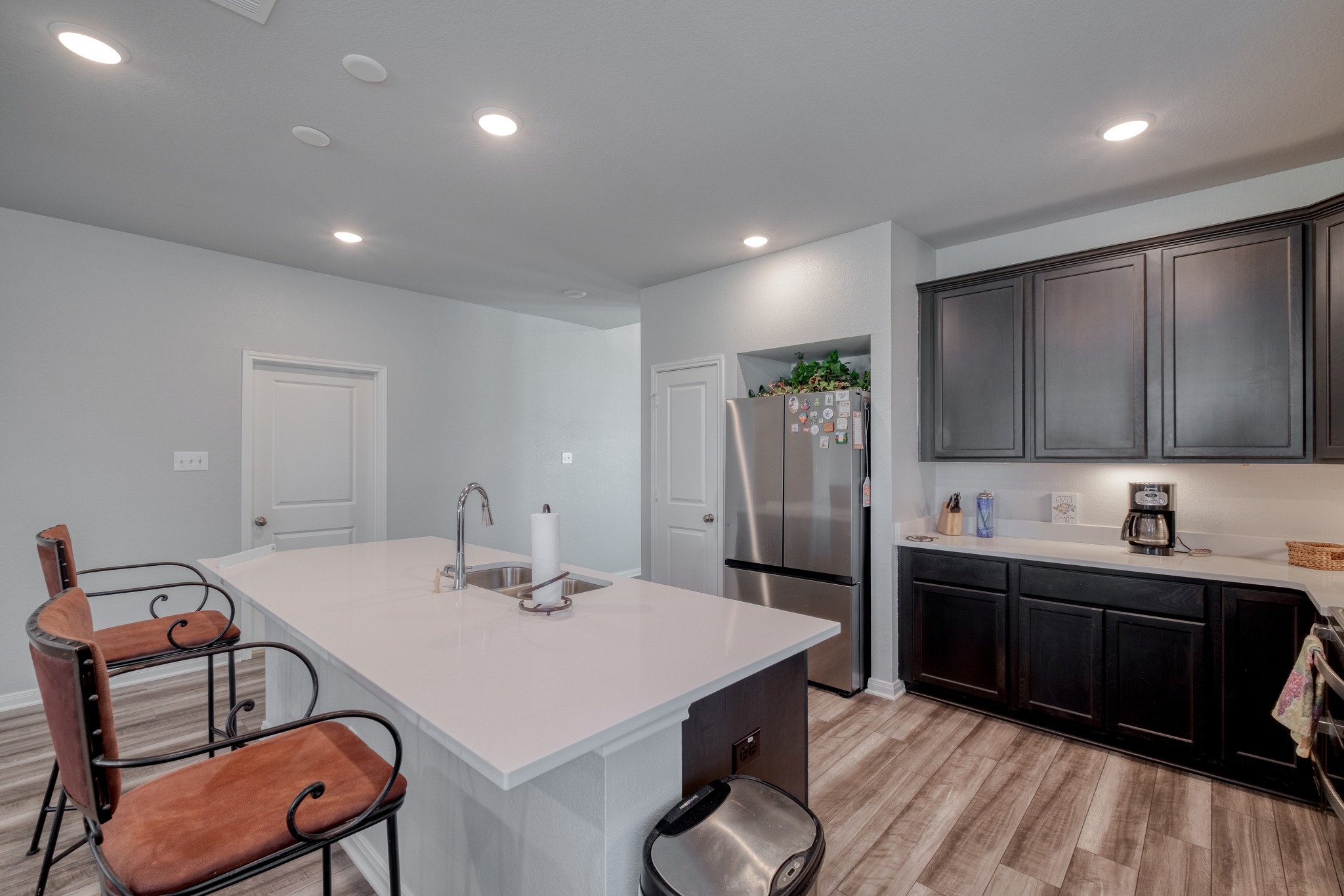 3500 Beutel Road Lorena, TX 76655 - Photo 11 of 27 Kitchen featuring freestanding refrigerator, light wood finished floors, a kitchen bar, a center island with sink, and recessed lighting