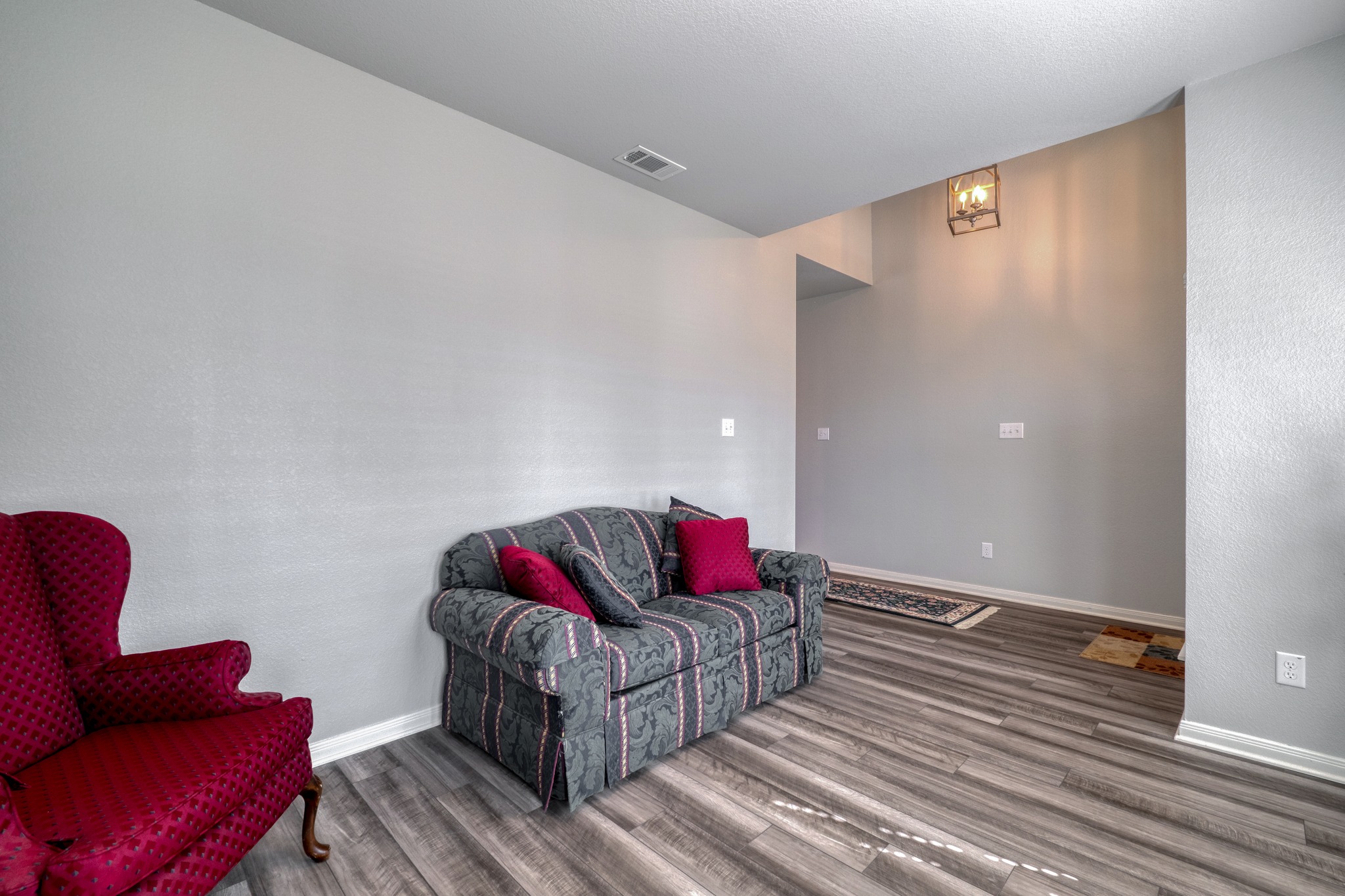 3500 Beutel Road Lorena, TX 76655 - Photo 15 of 27 Living area with wood finished floors and a textured wall