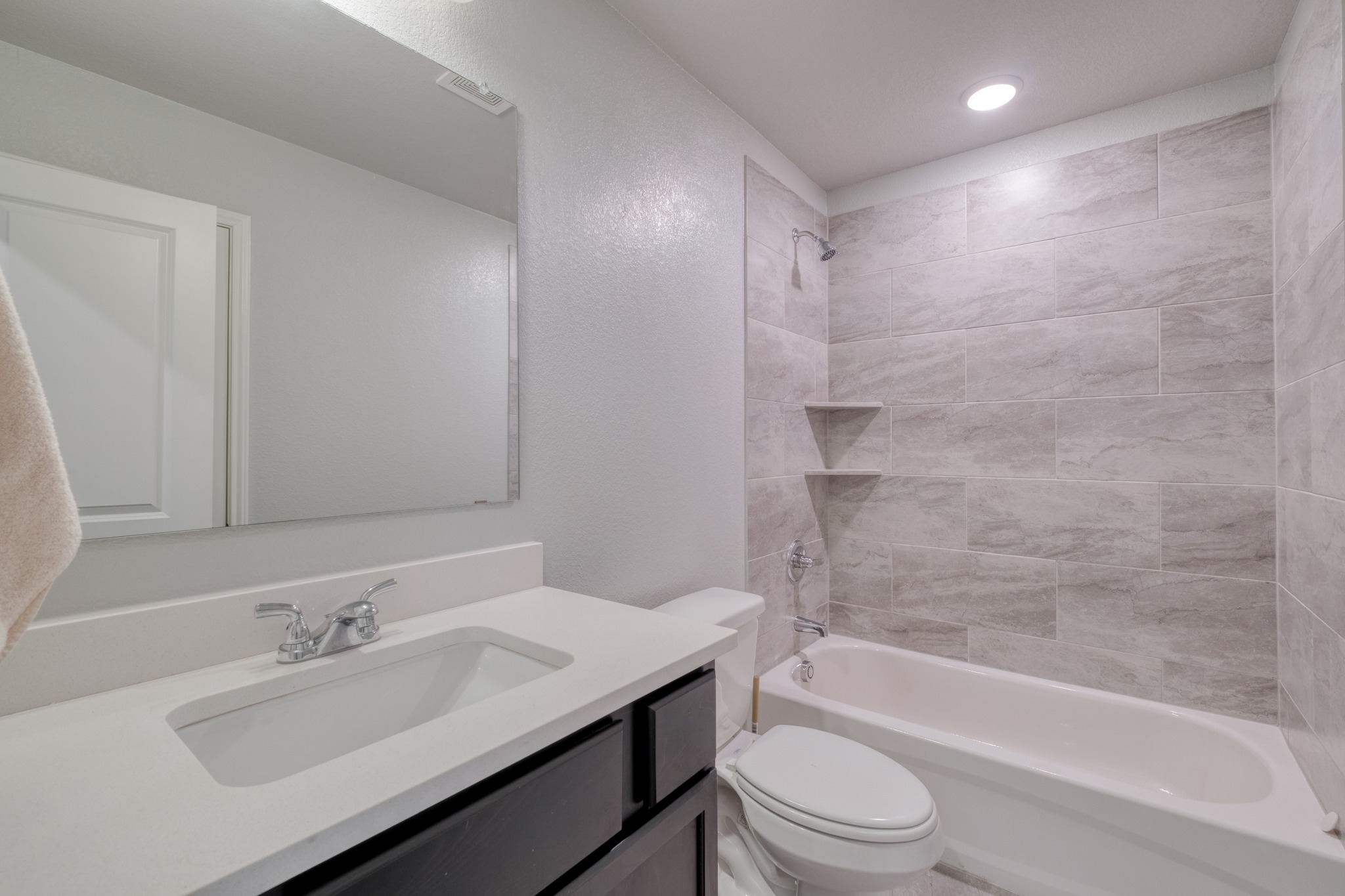 3500 Beutel Road Lorena, TX 76655 - Photo 21 of 27 Bathroom featuring vanity, bathing tub / shower combination, a textured wall, and recessed lighting
