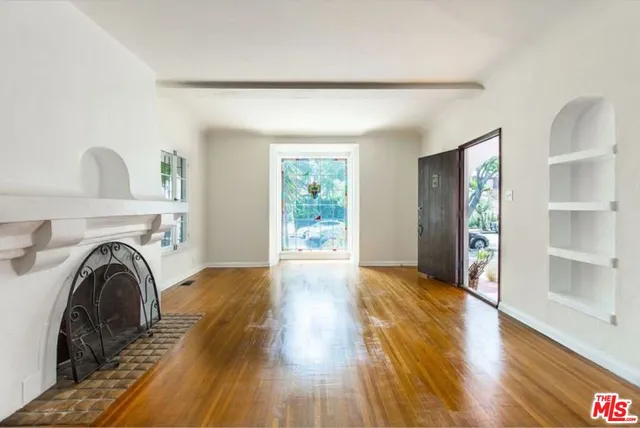 a kitchen with granite countertop a stove and a wooden floors