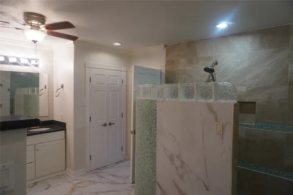 a bathroom with a shower and a sink
