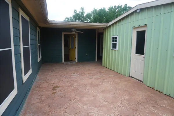 a view of a small house with backyard