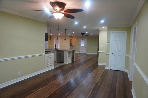 a view of a kitchen with a sink and wooden floor