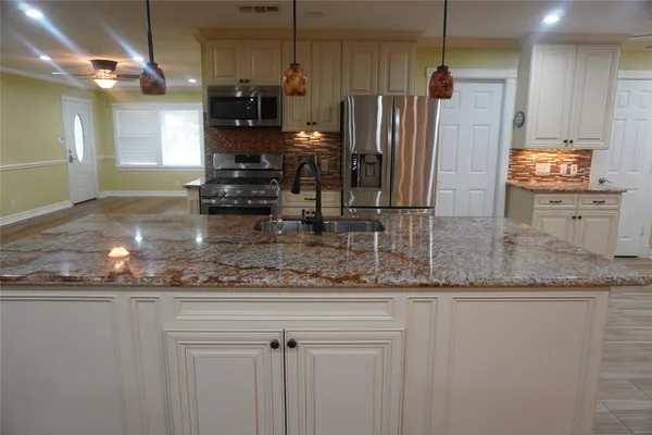 a kitchen with a refrigerator and microwave