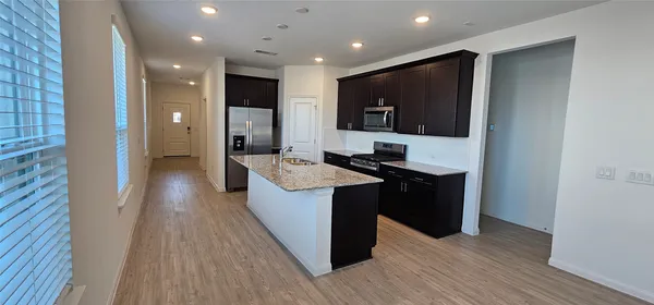 a kitchen with a sink and a refrigerator