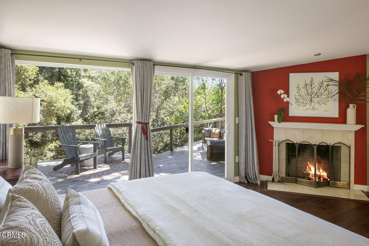 1453 Wicks Road Pasadena, CA 91103 - Photo 19 of 31 a bedroom with a balcony a bed and a fireplace