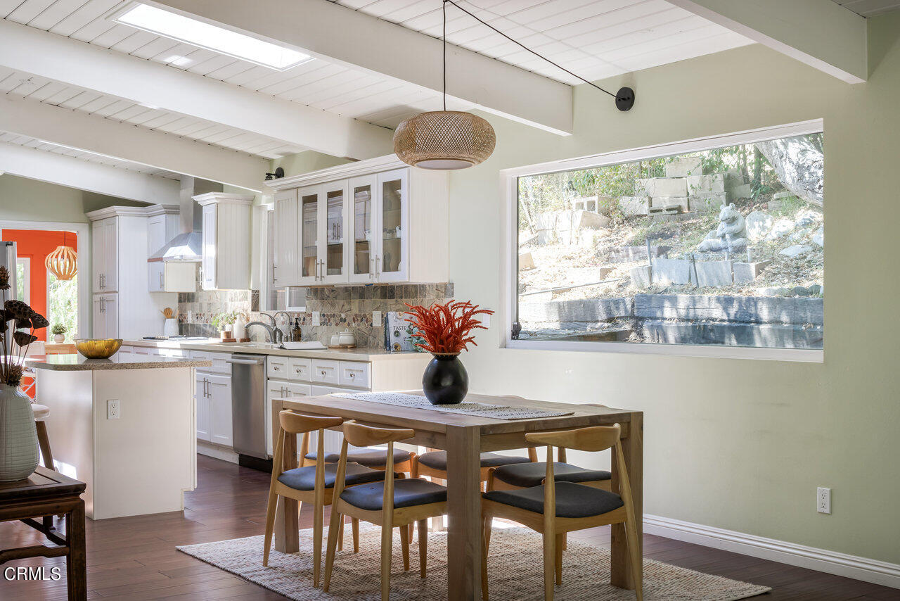 1453 Wicks Road Pasadena, CA 91103 - Photo 7 of 31 a kitchen with stainless steel appliances granite countertop a table chairs sink and cabinets