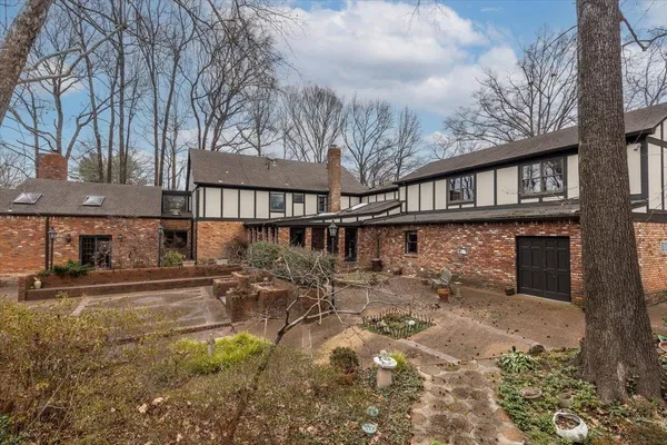 a view of a house with yard and sitting area