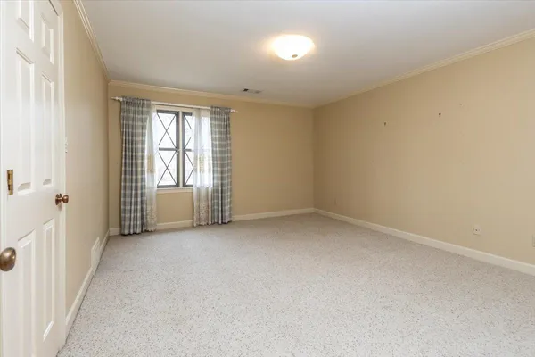 a spacious bedroom with a bed and a couch