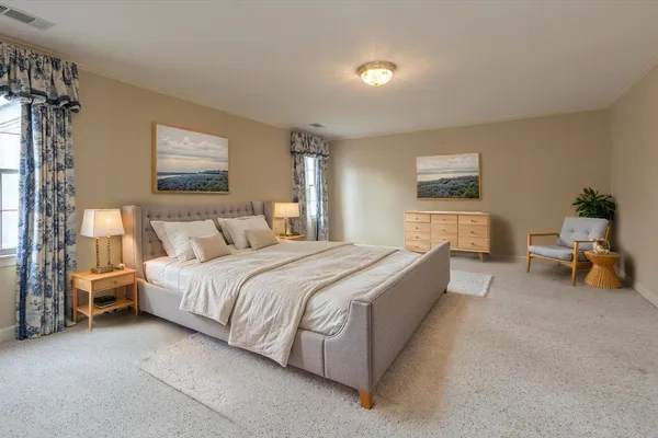 a living room with furniture and a ceiling fan