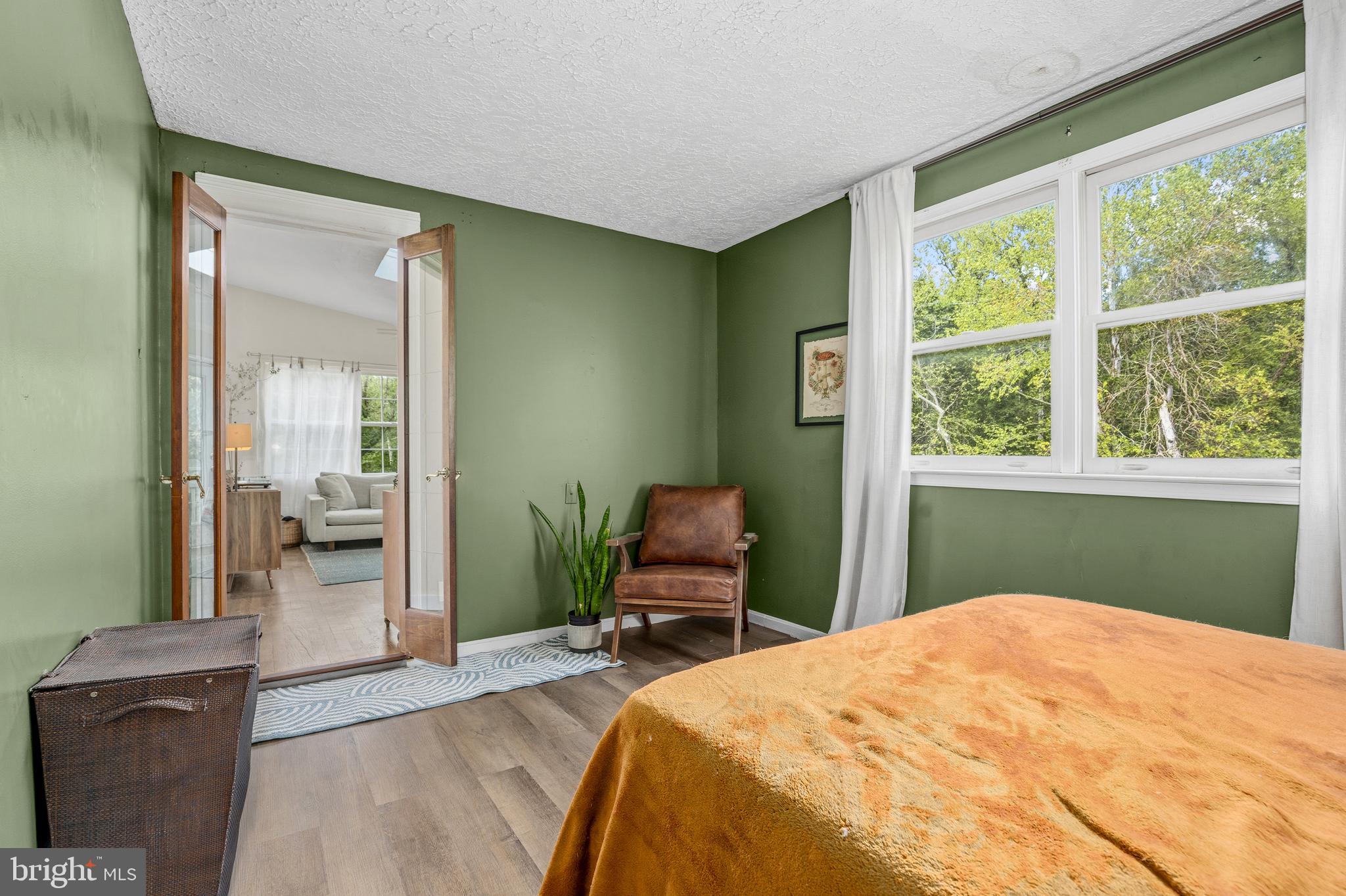 11216 Tippett Road Clinton, MD 20735 - Photo 17 of 26 a bedroom with a bed and wooden floor