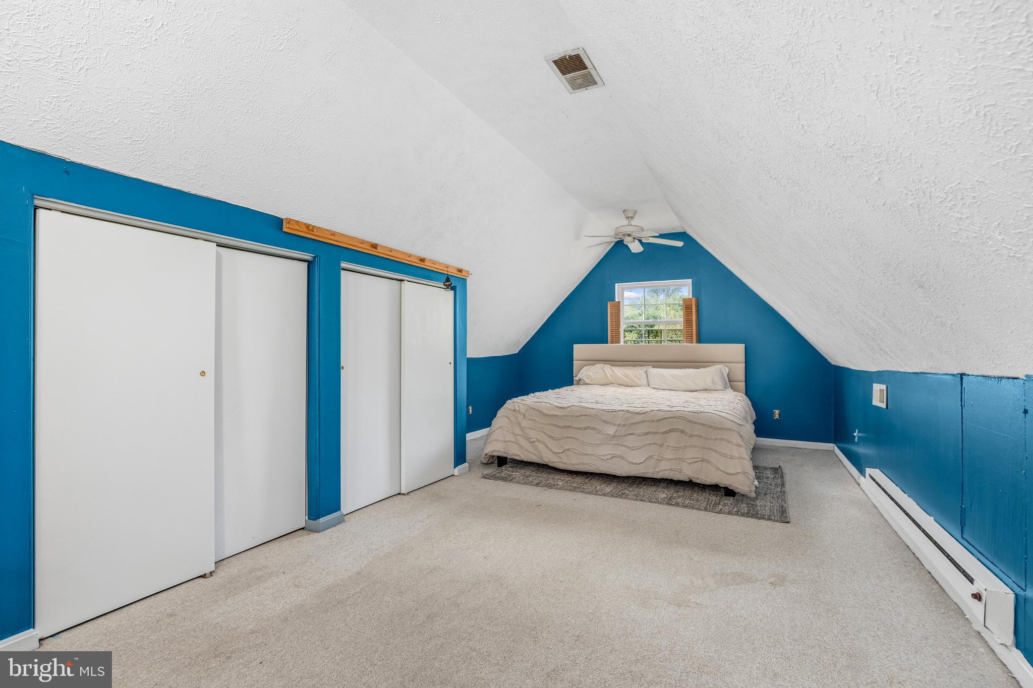 11216 Tippett Road Clinton, MD 20735 - Photo 19 of 26 a spacious bedroom with a bed and a dresser with wooden floor