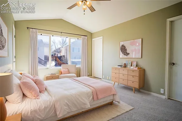 a bedroom with a bed and a large window